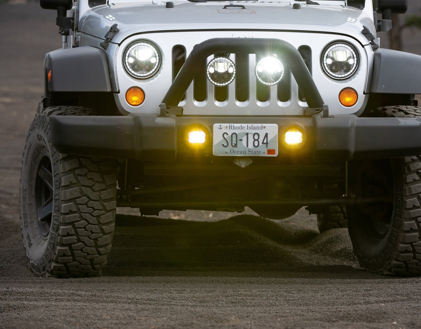 Jeep Wrangler with LED fog light upgrade lit at dusk